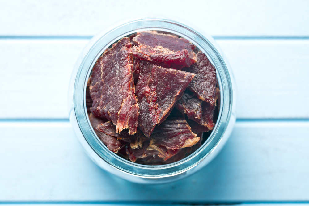 Beef jerky in a small glass bowl.