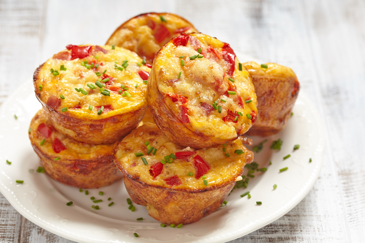 Delicious egg muffins with ham, cheese and vegetables baked in a muffin tin for a quick weight loss breakfast from Personal Trainer Food. 