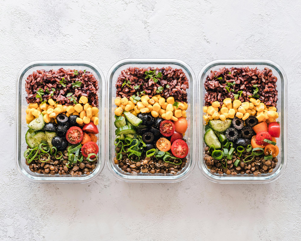 Low glycemic meal planning with balanced low GI meals in three trays on a table